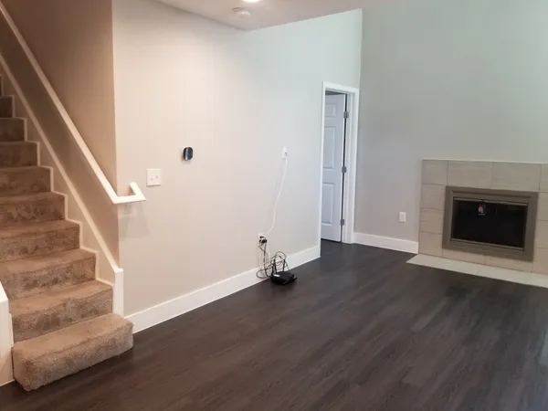 wooden floor in an empty room with a fireplace