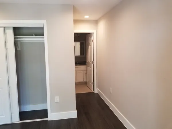 a view of hallway with wooden floor