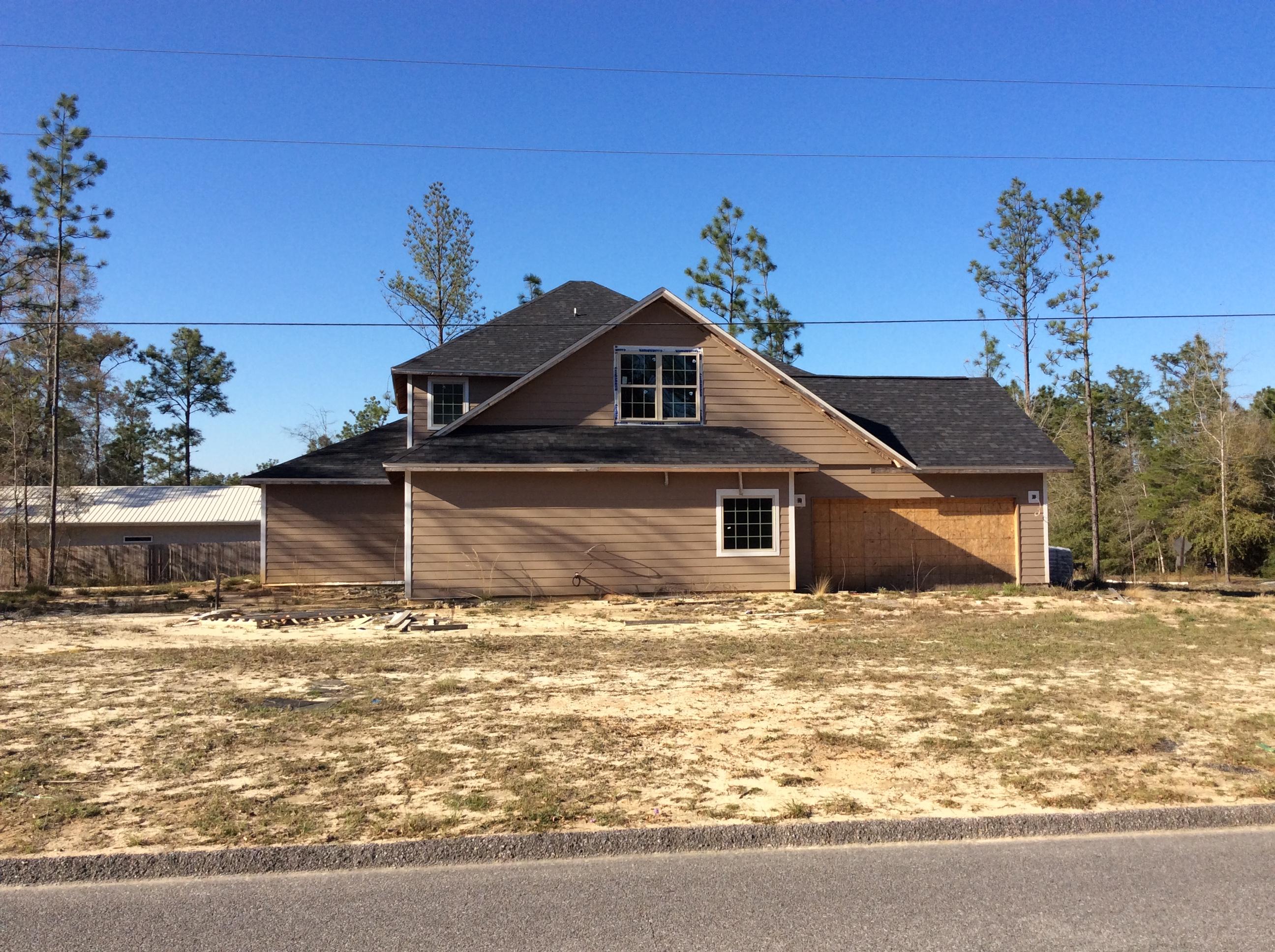 6310 Possum Ridge Road Crestview, FL 32539 - Photo 2 of 23 a white house that has a tree in front of it