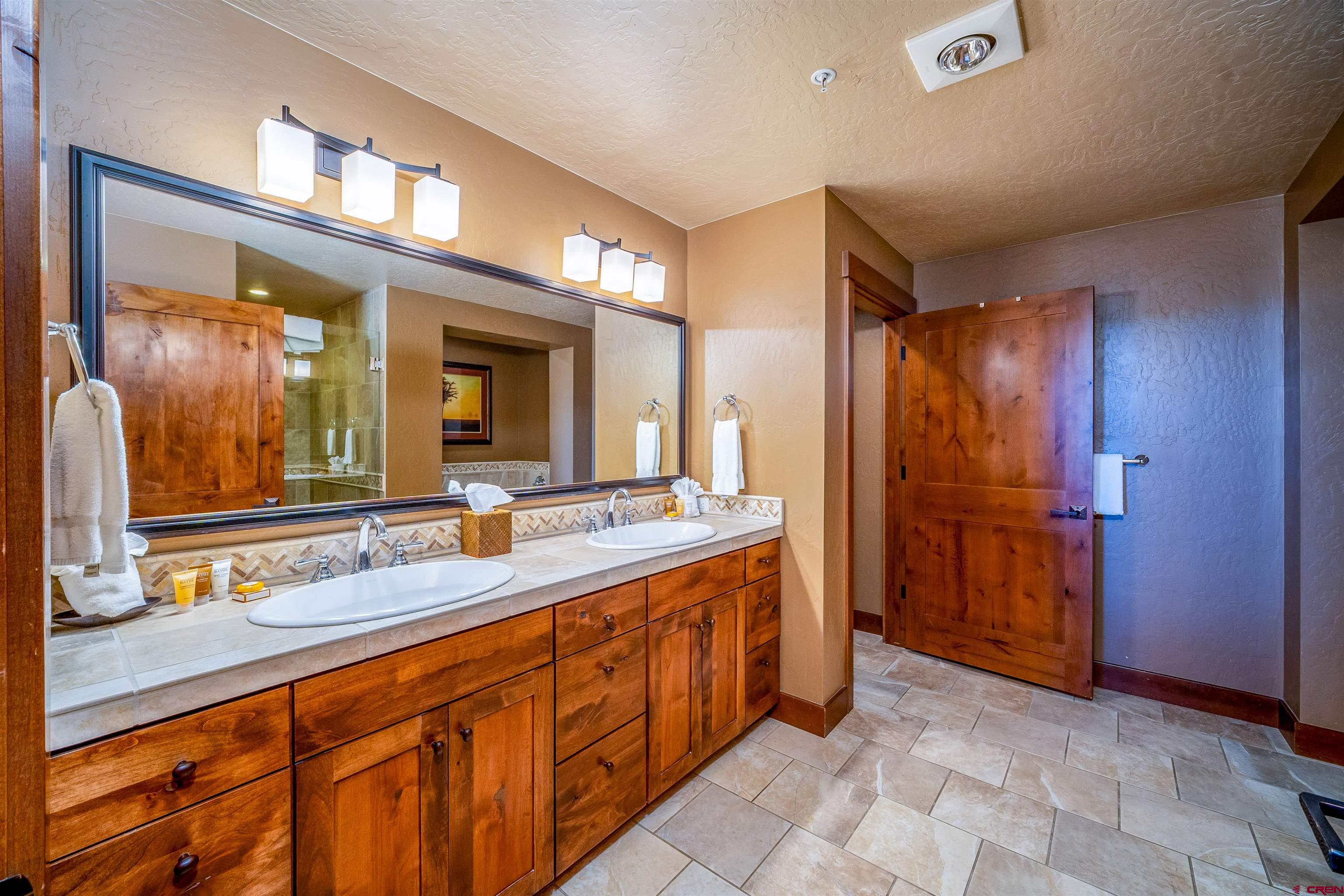 24 Sheol Street, Unit 205 Durango, CO 81301 - Photo 11 of 39 a bathroom with a double vanity sink and a mirror