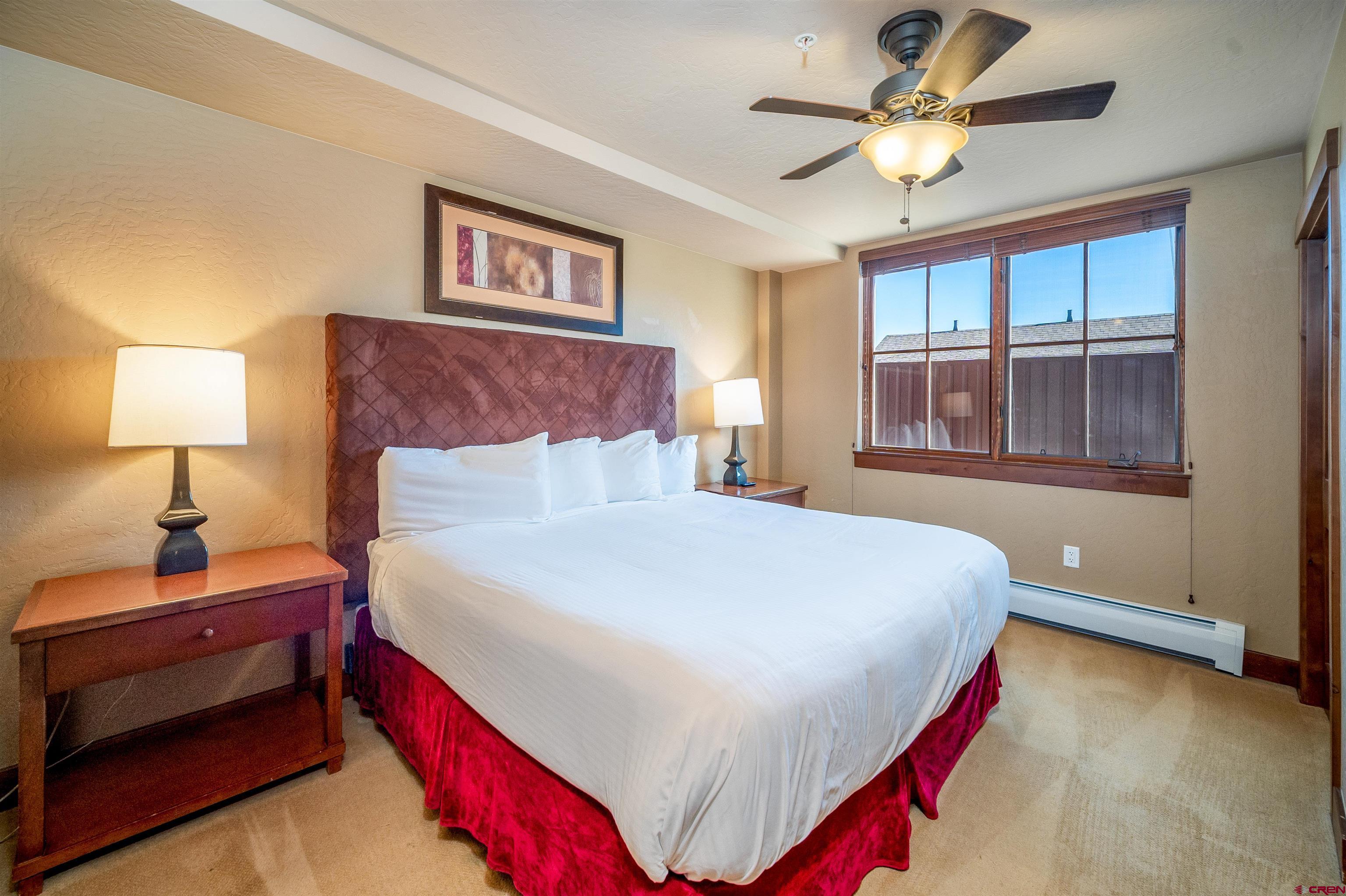 24 Sheol Street, Unit 205 Durango, CO 81301 - Photo 15 of 39 a bedroom with a large bed and a chandelier