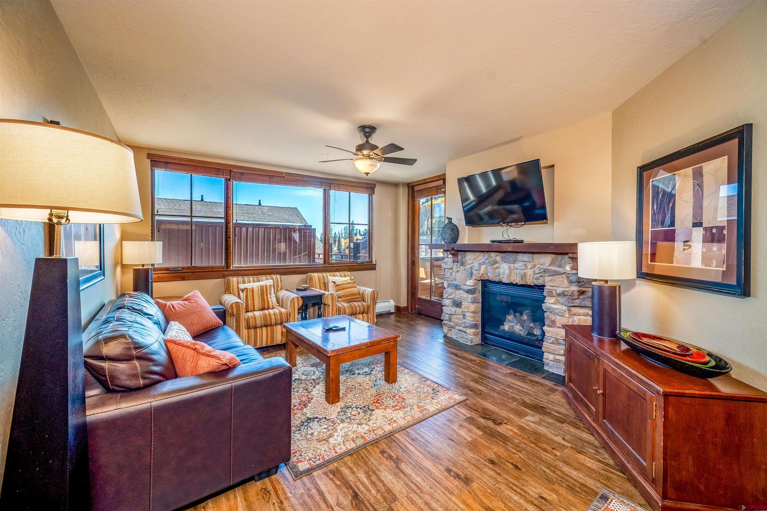 24 Sheol Street, Unit 205 Durango, CO 81301 - Photo 3 of 39 a living room with furniture a fireplace and a flat screen tv