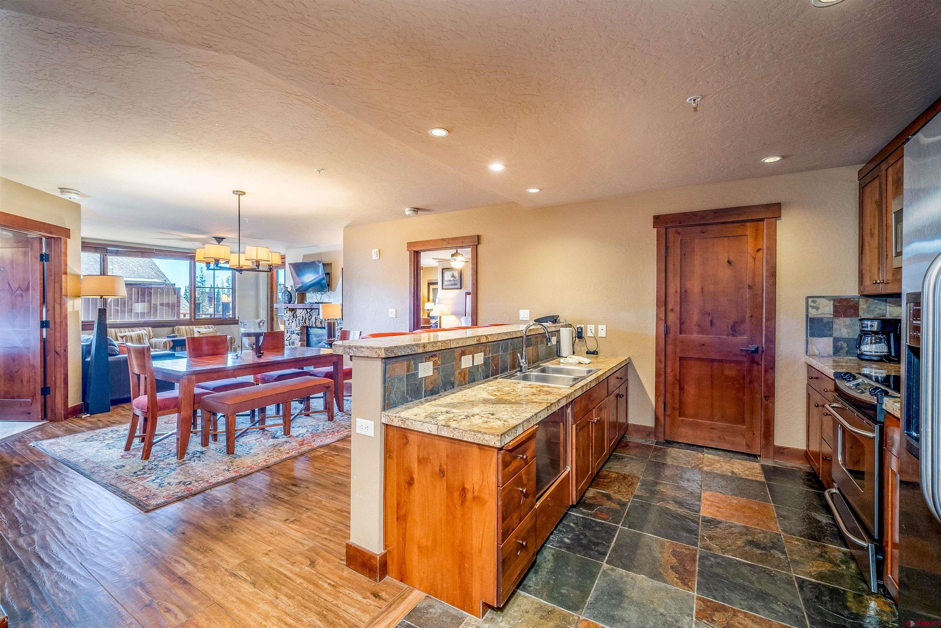 24 Sheol Street, Unit 205 Durango, CO 81301 - Photo 5 of 39 a large kitchen with stainless steel appliances granite countertop a large counter top and a wooden floors