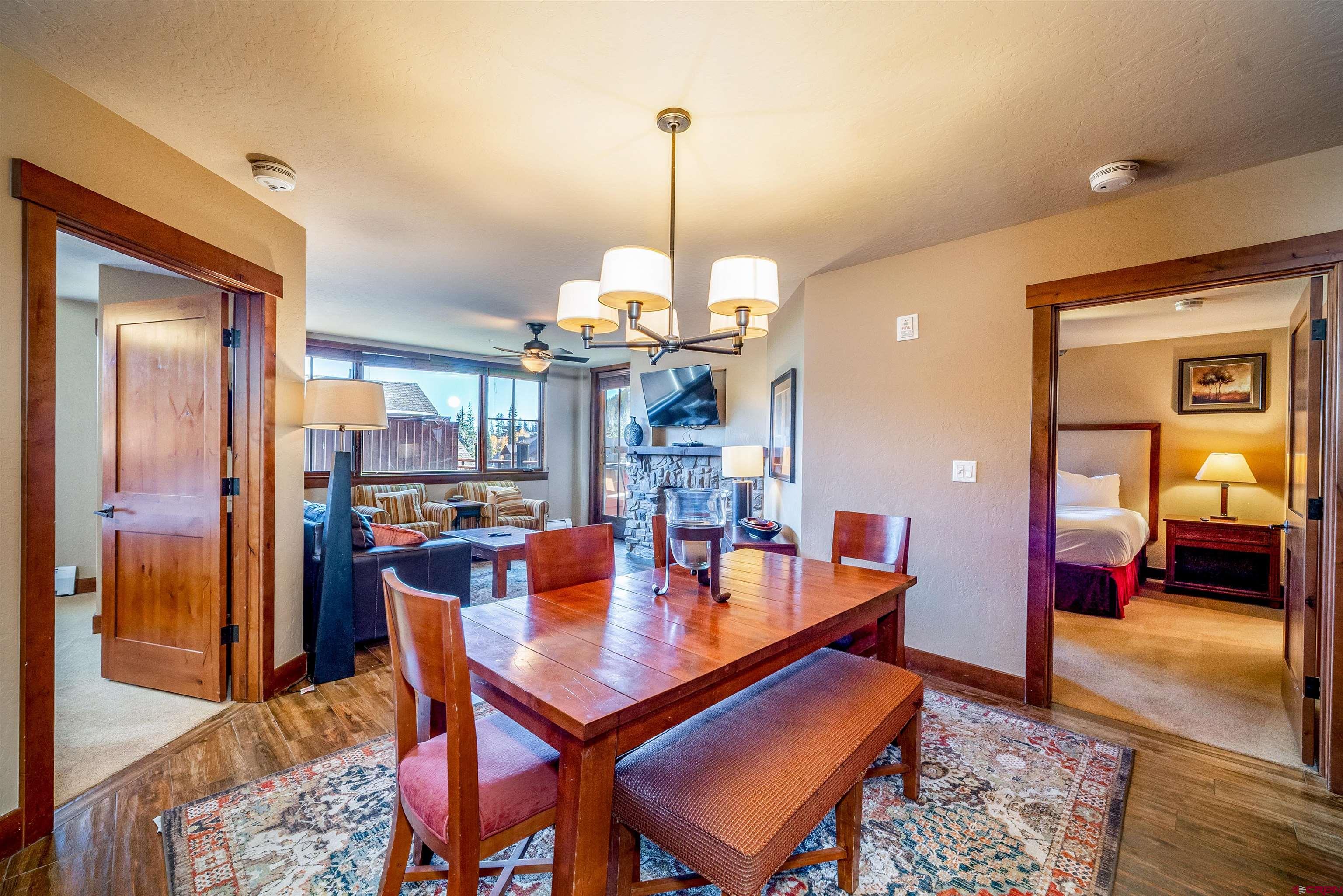 24 Sheol Street, Unit 205 Durango, CO 81301 - Photo 8 of 39 a dining room with furniture a chandelier and wooden floor