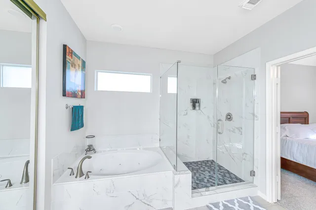 a bathroom with a tub shower and a sink