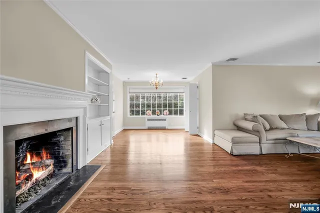 a view of livingroom with hardwood floor and a kitchen