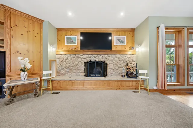 a living room with fireplace furniture and a flat screen tv