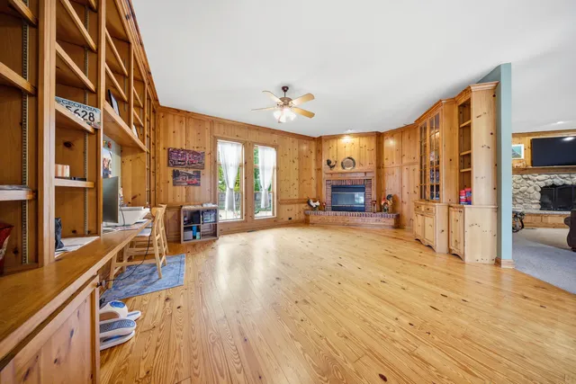 a view of a living room and a kitchen with wooden floor