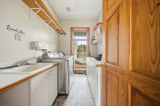 a hallway with sink and mirror