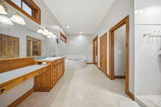 a large bathroom with a large mirror vanity and a sink