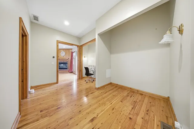 a view of empty room with wooden floor