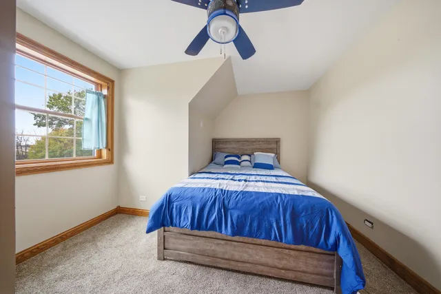 a bedroom with a bed and window