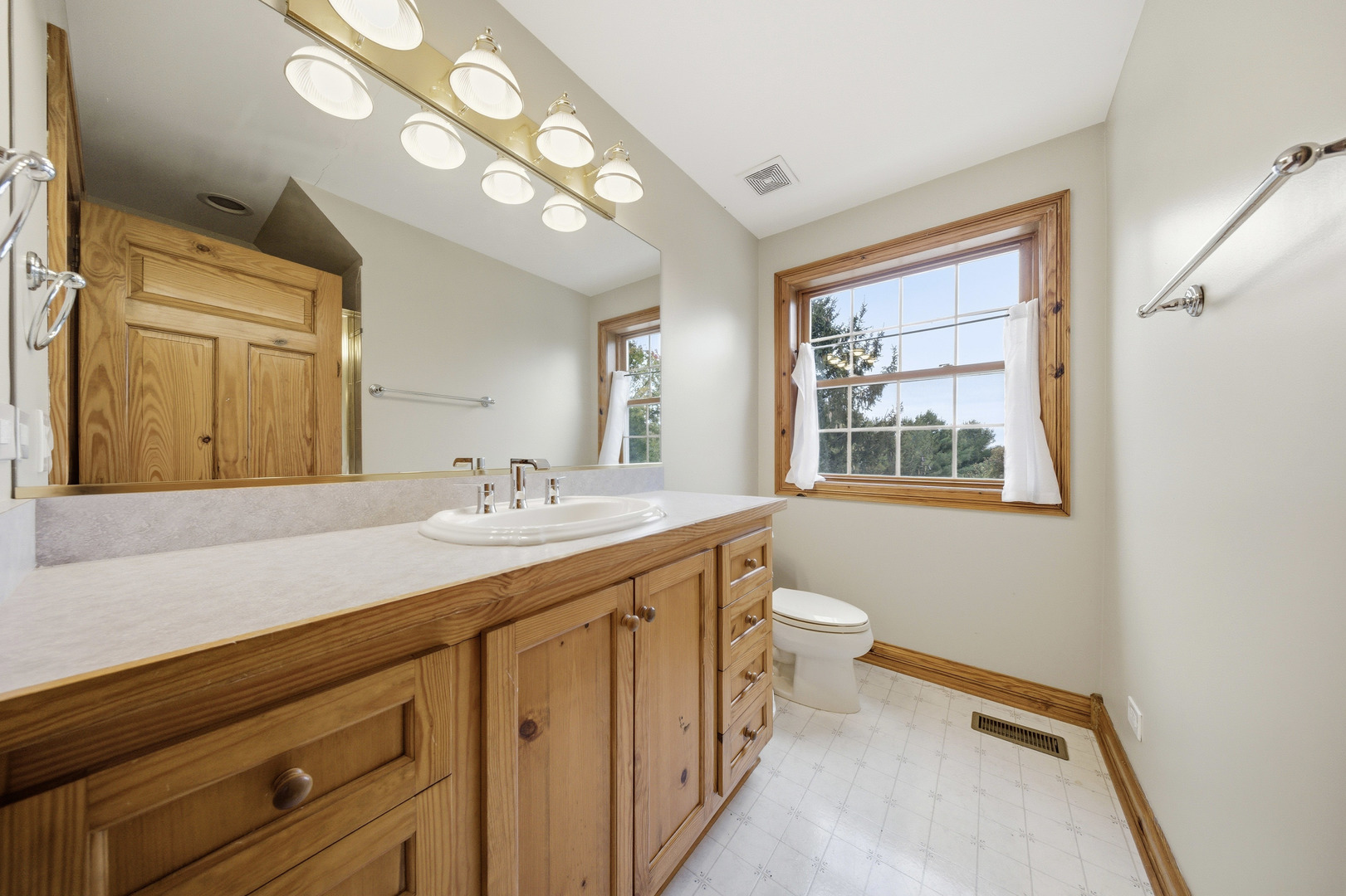 10731 Somonauk Road Hinckley, IL 60520 - Photo 42 of 48 a bathroom with a granite countertop sink mirror and a toilet