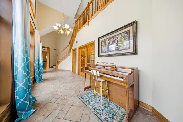 a view of a hallway with furniture and a chandelier