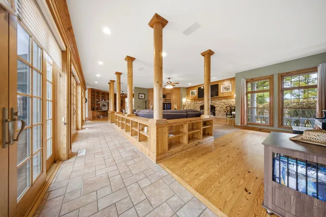 a view of a living room with furniture and floor to ceiling windows