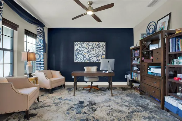 a view of a dining room and livingroom with furniture wooden floor a chandelier