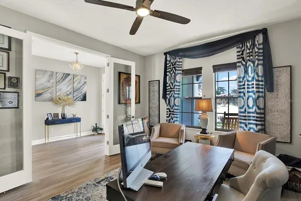 a kitchen with stainless steel appliances kitchen island granite countertop a dining table chairs sink and cabinets