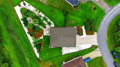 a front view of a house with a garden and plants