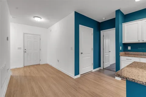 a view of a room with wooden floor and window
