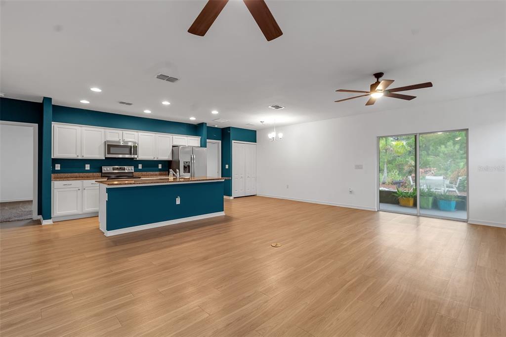 4322 Kiska Road North Port, FL 34288 - Photo 15 of 67 an open kitchen with kitchen island wooden floor and center island