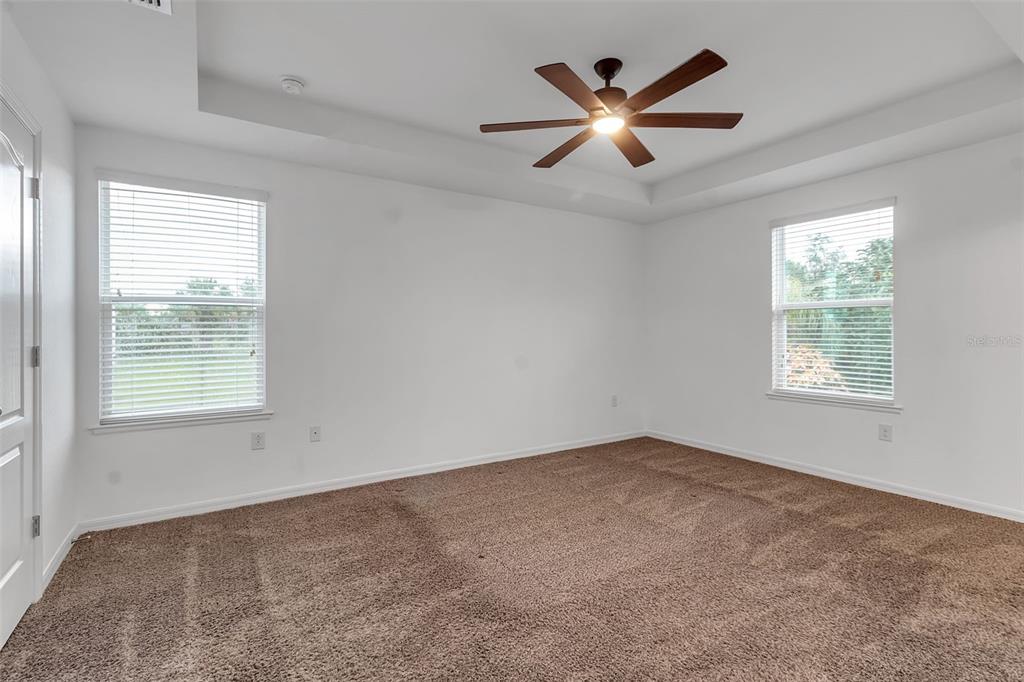 4322 Kiska Road North Port, FL 34288 - Photo 20 of 67 an empty room with ceiling fan and windows