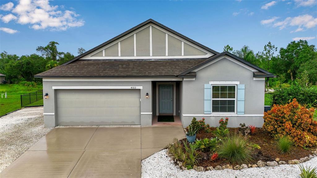 4322 Kiska Road North Port, FL 34288 - Photo 2 of 67 a front view of a house with a garden and plants