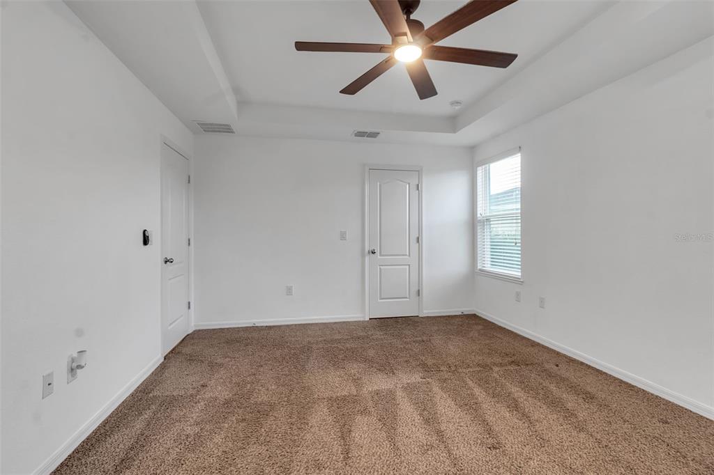 4322 Kiska Road North Port, FL 34288 - Photo 21 of 67 an empty room with a window and a fan