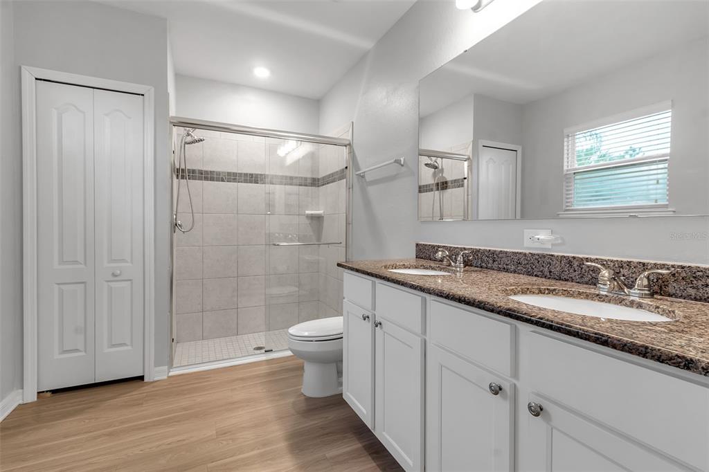 4322 Kiska Road North Port, FL 34288 - Photo 23 of 67 a bathroom with a granite countertop sink a toilet and shower