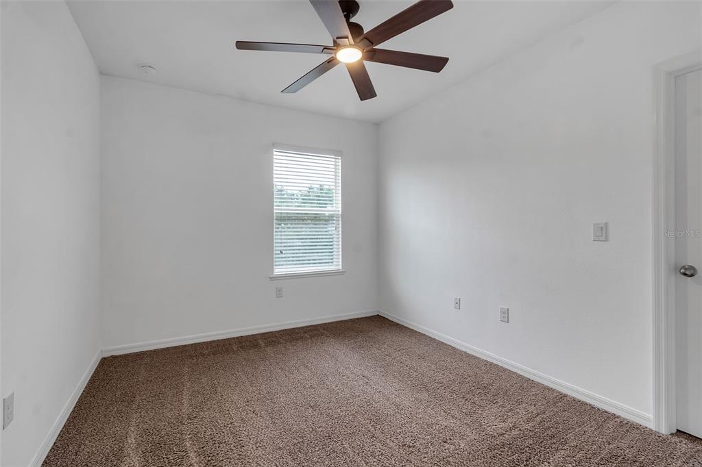 4322 Kiska Road North Port, FL 34288 - Photo 26 of 67 an empty room with a window and a fan