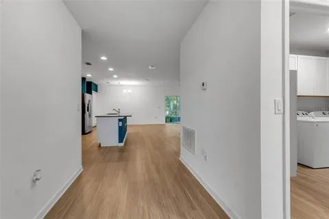 a kitchen with stainless steel appliances granite countertop a refrigerator a stove top oven and a sink