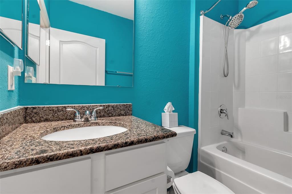 4322 Kiska Road North Port, FL 34288 - Photo 31 of 67 a bathroom with a granite countertop sink and a mirror