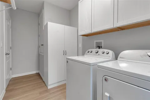 a view of a house with backyard and a tree