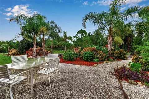 an aerial view of house with swimming pool outdoor seating and yard