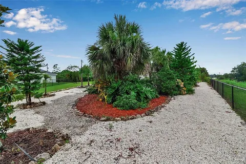 an aerial view of residential houses with outdoor space and street view