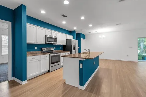 a kitchen with stainless steel appliances granite countertop a sink stove and microwave