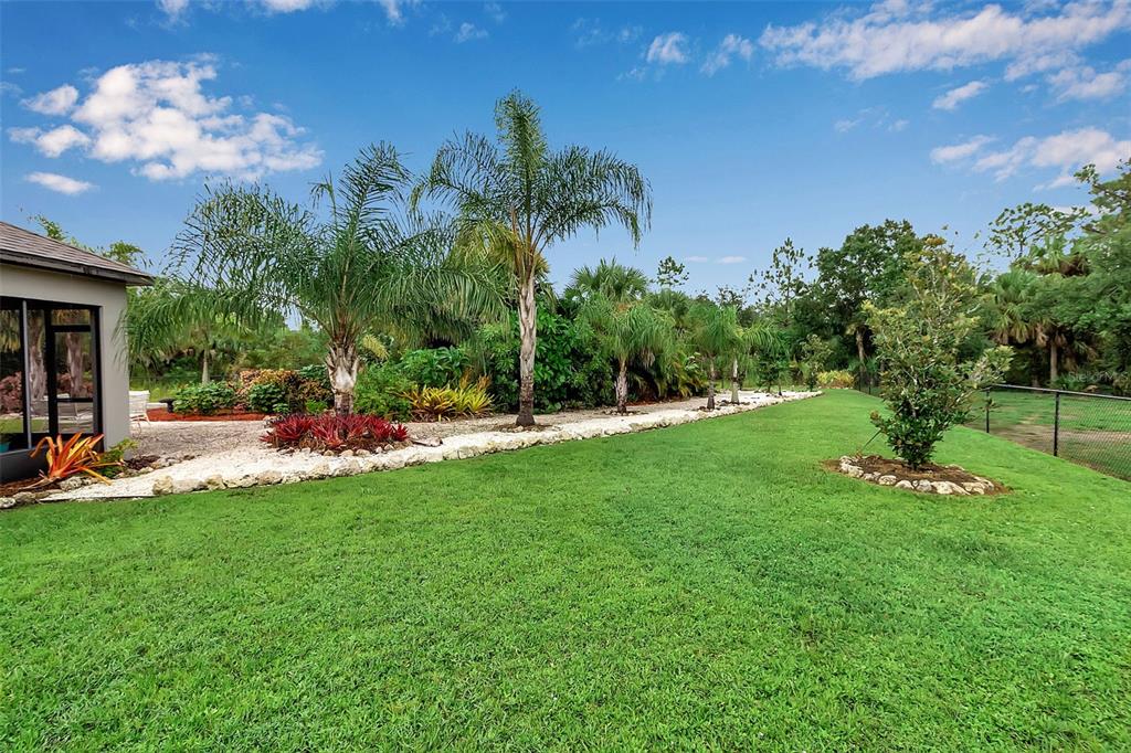 4322 Kiska Road North Port, FL 34288 - Photo 54 of 67 a view of a garden with a building in the background