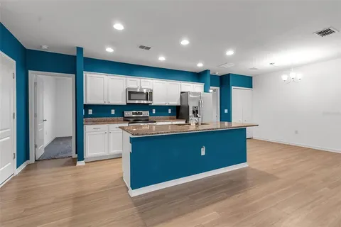 a kitchen with stainless steel appliances granite countertop a stove and a sink