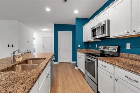 a view of a kitchen from the hallway