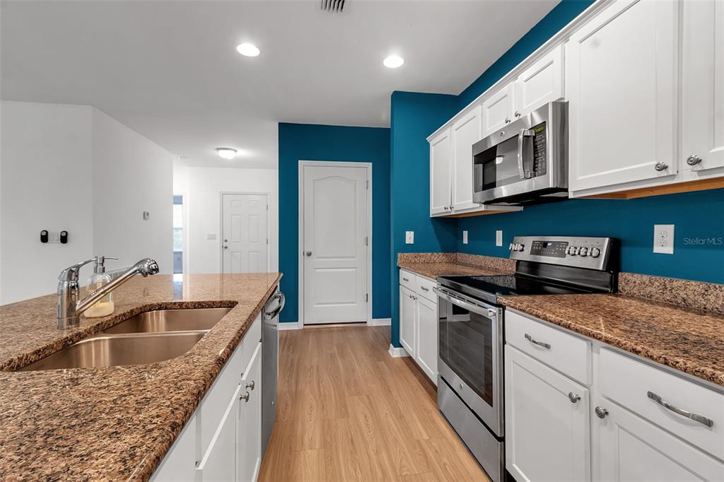 4322 Kiska Road North Port, FL 34288 - Photo 9 of 67 a kitchen with stainless steel appliances granite countertop a sink stove and microwave