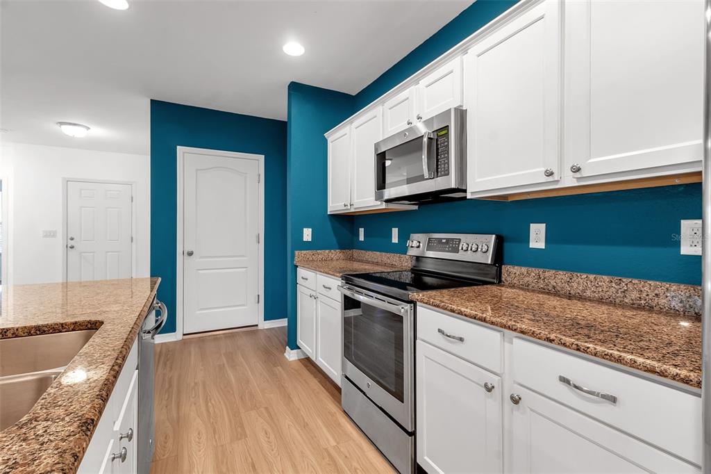 4322 Kiska Road North Port, FL 34288 - Photo 10 of 67 a kitchen with stainless steel appliances granite countertop a stove and a sink