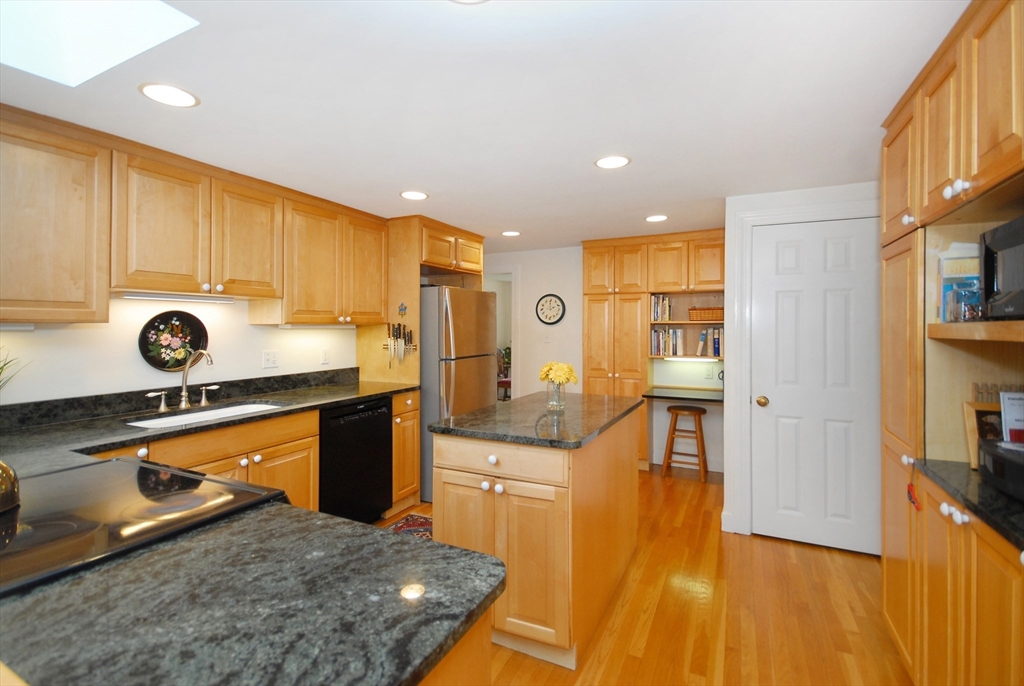 51 MacArthur Road Concord, MA 01742 - Photo 14 of 42 a kitchen with a sink a stove and a wooden cabinets
