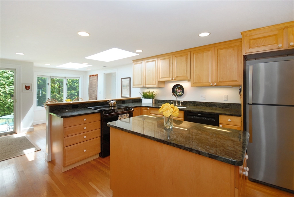 51 MacArthur Road Concord, MA 01742 - Photo 15 of 42 a kitchen with stainless steel appliances granite countertop a refrigerator a sink and a stove