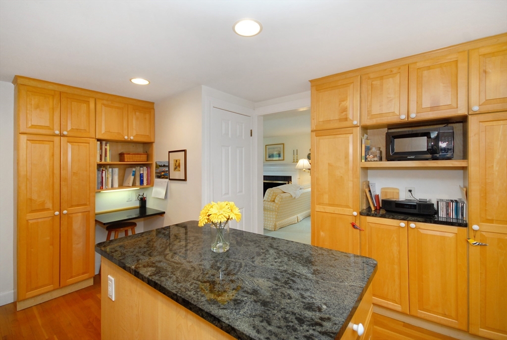 51 MacArthur Road Concord, MA 01742 - Photo 16 of 42 a kitchen with stainless steel appliances granite countertop a sink refrigerator and cabinets