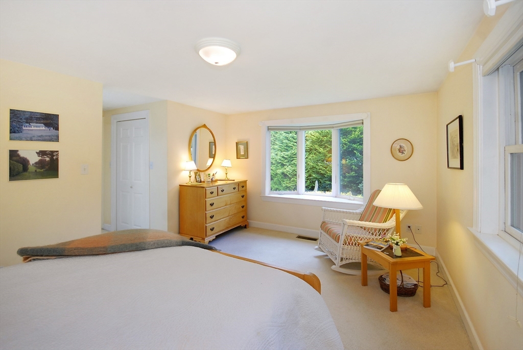 51 MacArthur Road Concord, MA 01742 - Photo 21 of 42 a bedroom with a bed and wooden floor