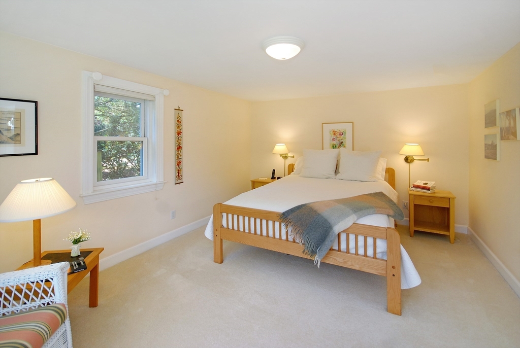 51 MacArthur Road Concord, MA 01742 - Photo 23 of 42 a bedroom with a bed chair and a lamp on table