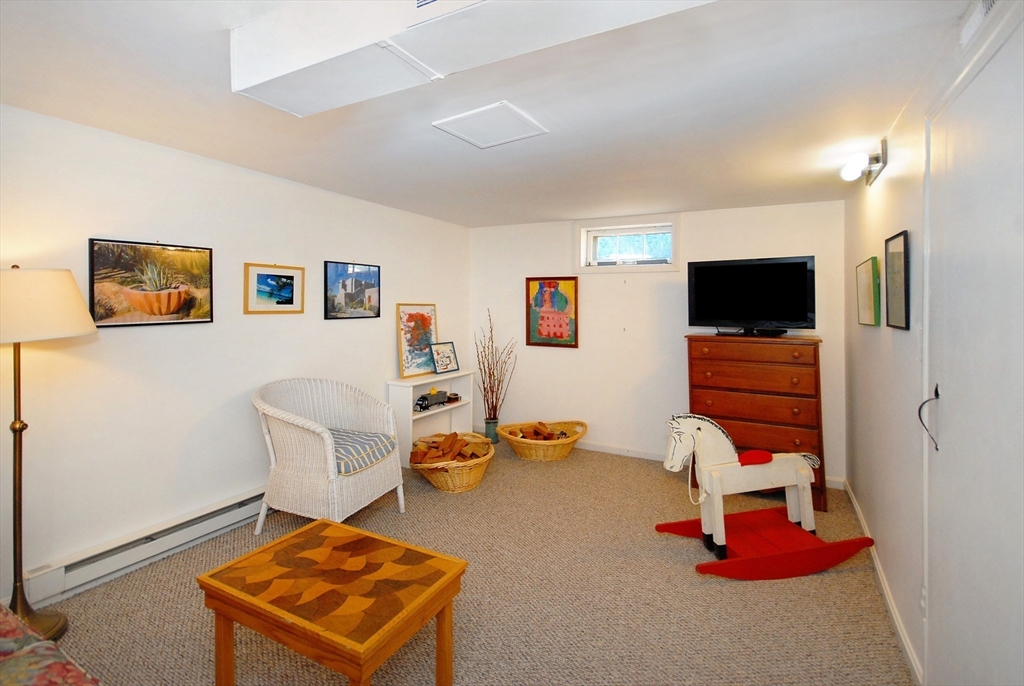 51 MacArthur Road Concord, MA 01742 - Photo 28 of 42 a living room with furniture and a flat screen tv
