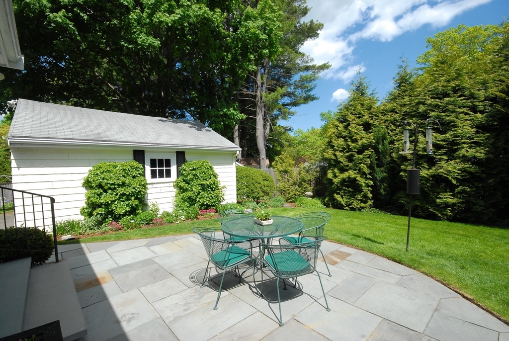 51 MacArthur Road Concord, MA 01742 - Photo 32 of 42 a view of a patio with table and chairs and potted plants