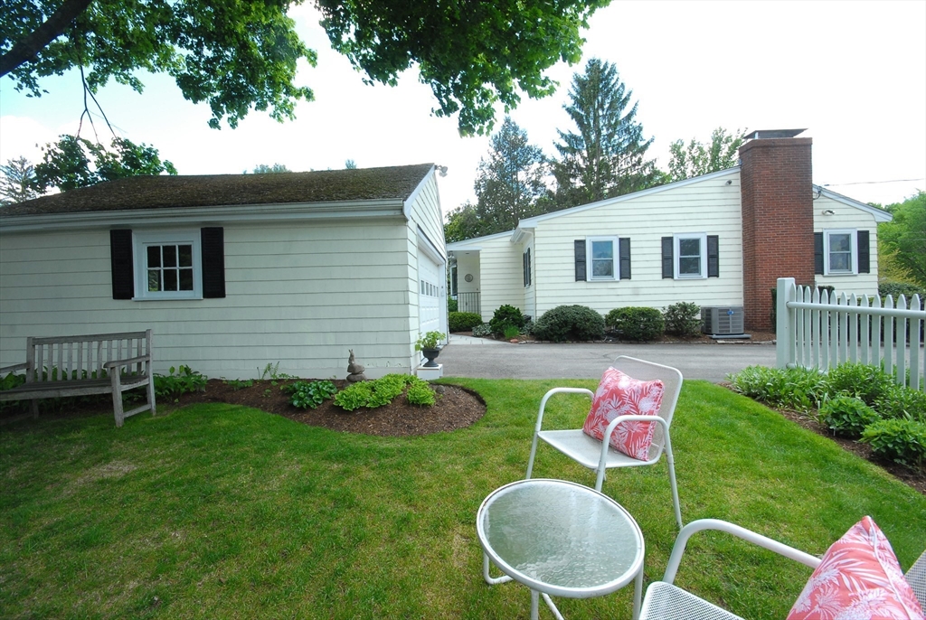51 MacArthur Road Concord, MA 01742 - Photo 36 of 42 a backyard of a house with table and chairs