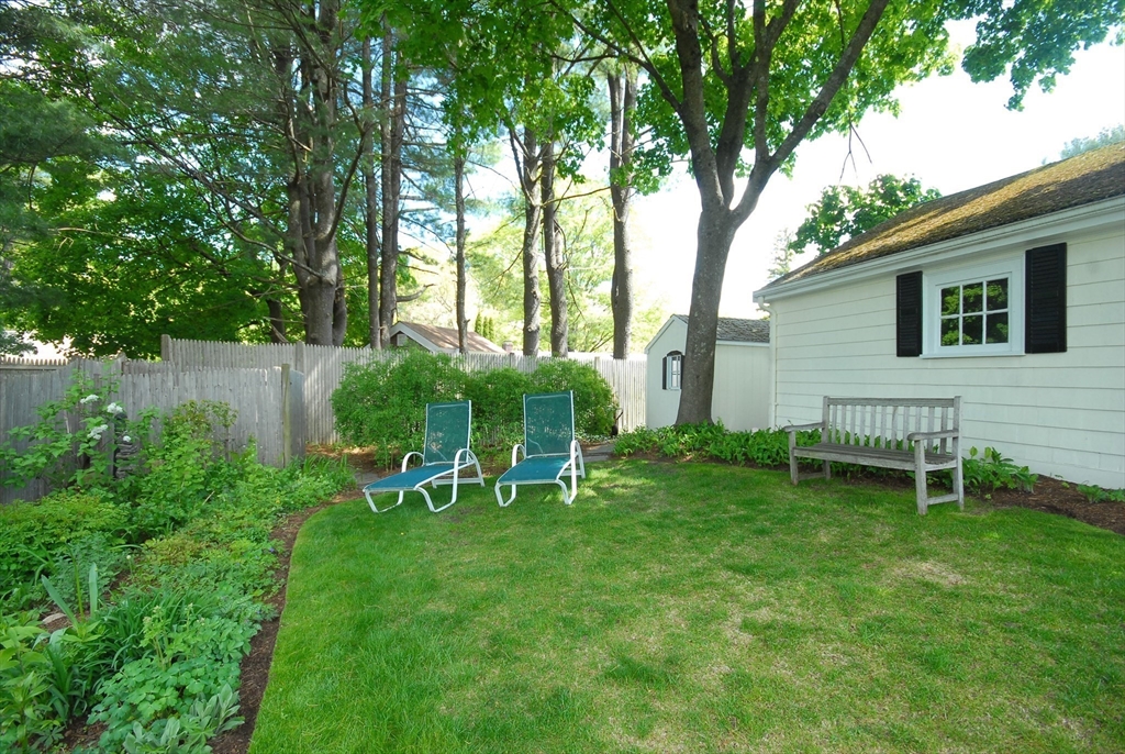 51 MacArthur Road Concord, MA 01742 - Photo 37 of 42 a view of backyard with table and chairs and a large tree