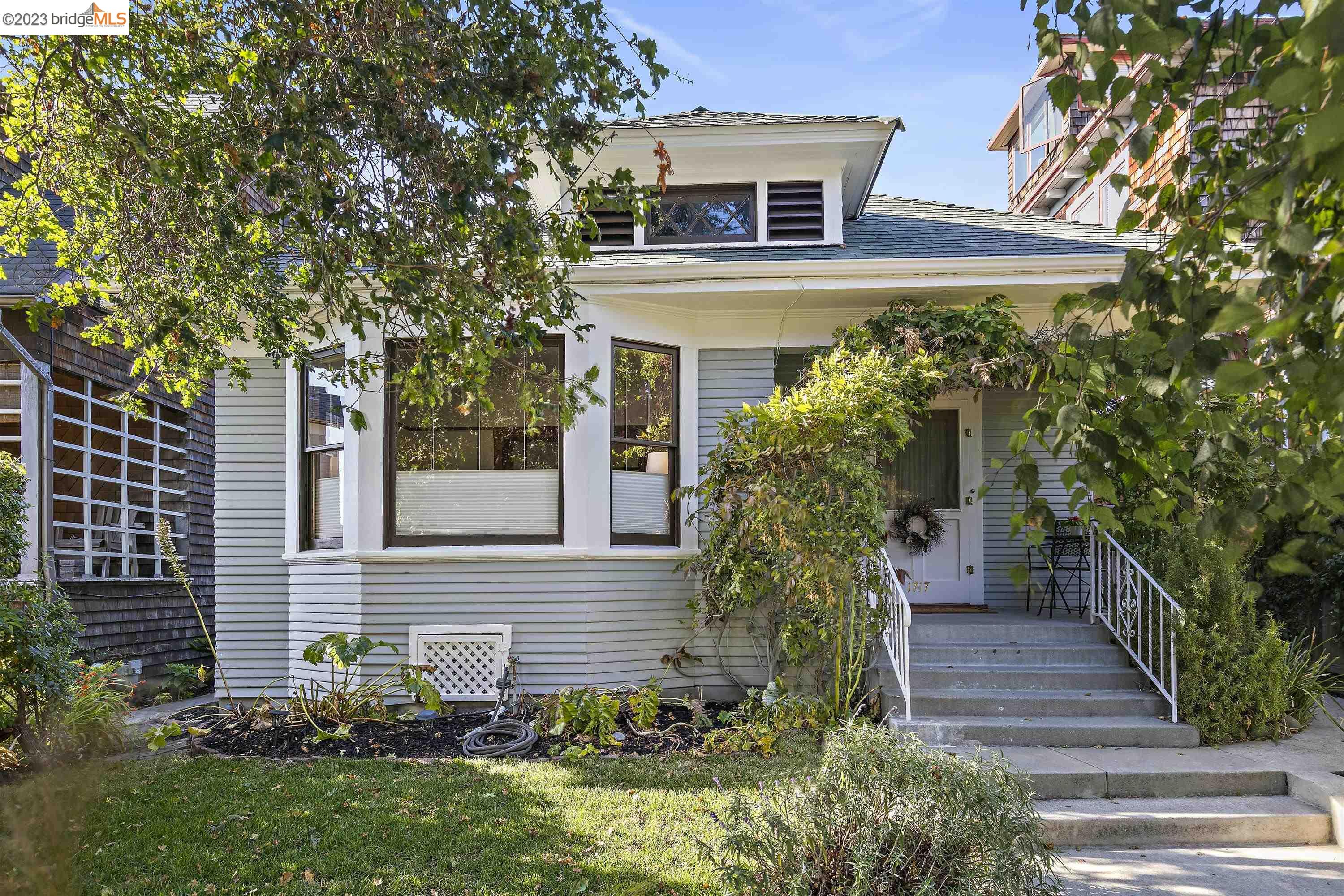 a front view of a house with plants